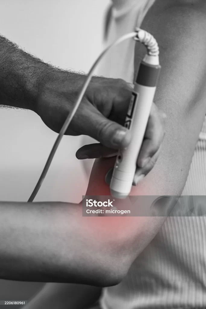 laser therapy to a patient's elbow