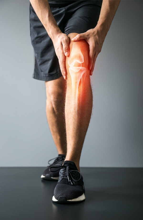 Man holding knee in pain