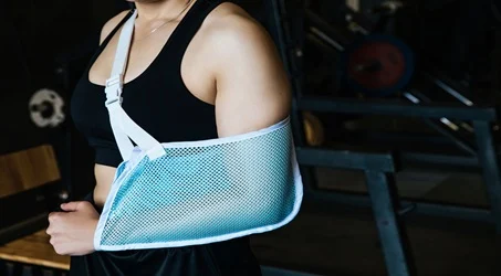 person wearing a blue mesh arm sling